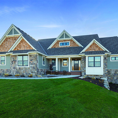 traditional house with natural wood shake accents and mixed materials exterior