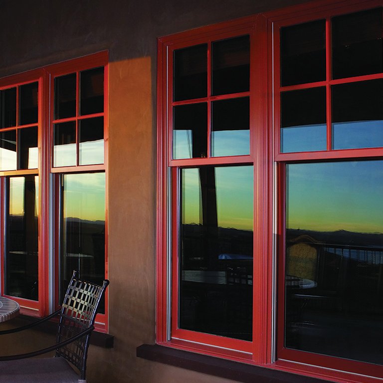 Exterior of brown house with red, aluminum Andersen Windows